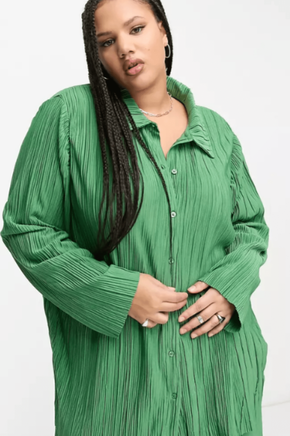 Woman in a green plisse button down and pants matching set from Asos.